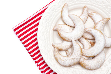 Traditional German or Austrian Vanillekipferl vanilla kipferl cookies on a plate isolated on white background