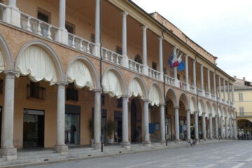 the portico of the goldsmiths in piazza del popolo in Faenza with columns in yellow Varignana's stone