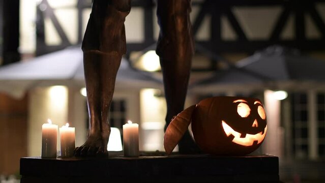 City street view with smiling pumpkin decorated with face for the upcoming Halloween holiday - candle light inside