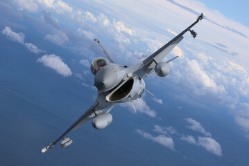 Naklejka premium Fighter jet flying over the clouds