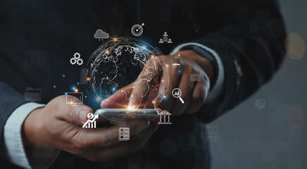 Businessman using mobile smartphone shows the future world of the metaverse with internet technology icons, Digital Marketing, Financial and banking, Metaverse, Digital link tech, Big data concept.