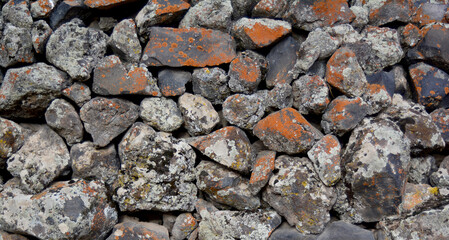 A wall lined with mossy stone