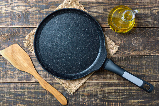 Culinary background with empty nonstick pancake pan. Rustic style.