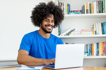 Laughing african american software engineer at computer