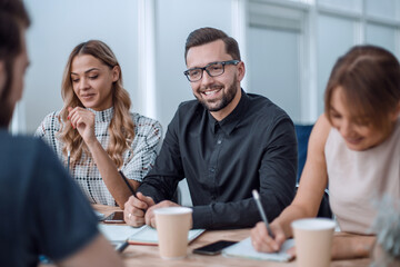 business team discussing business issues over a Cup of coffee