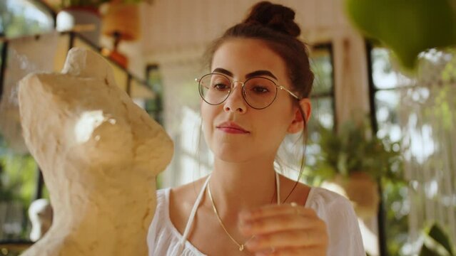A Young Beautiful Woman Creates A Sculpture Of A Female Body From Clay, Creates Modern Art, An Independent Freelance Businesswoman Relaxes In Her Free Time After Work, In An Art Studio In Sunset