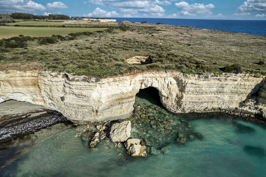 Coast of island of Otranto, Puglia, Salento, Italy. Turquoise sea, clear blue sky, rocks, sun, Tourist Apulia, Aerial View Sea