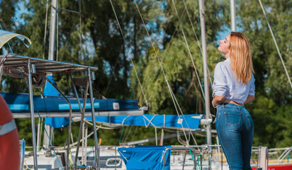 Attractive woman in yacht club, sunny warm day. Relax and freedom concept 