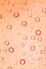 Water bubble on red glass.