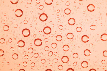 Water bubble on red glass.