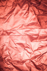 Crumpled red aluminum foil background.