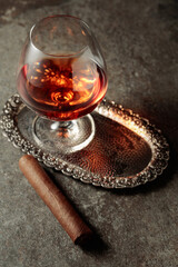 Snifter of brandy and cigar.
