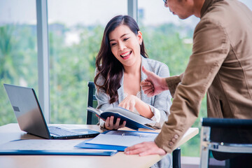 Asian Young teamwork meeting and discuss at the meeting room in office for smooth business ,colleagues,partnership, goal achievement concept.