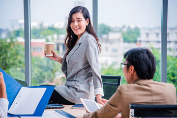 Asian Young teamwork meeting and discuss at the meeting room in office for smooth business ,colleagues,partnership, goal achievement concept.