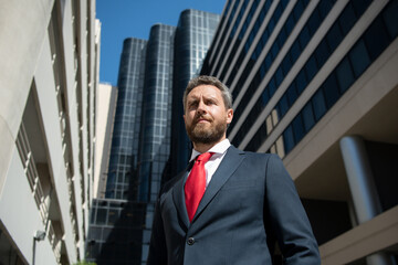 Portrait of businessman in front of modern office.