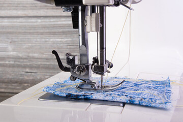Sewing machine. Closeup the sewing machine and item of clothing.