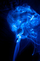 Fototapeta premium Blue smoke on black background.