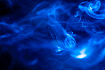 Blue smoke on black background.