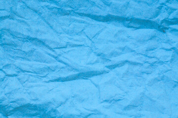 Blue crumpled paper background.