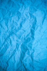 Blue crumpled paper background.