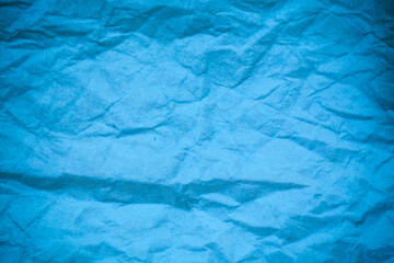 Blue crumpled paper background.