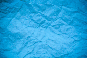 Blue crumpled paper background.