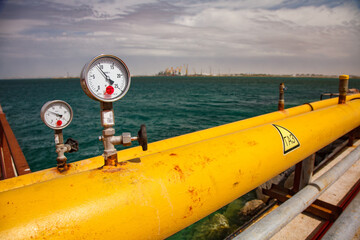Yellow gas transportation pipe with manometer gauges. Caspian Sea, Aktau LPG gas tanker ship...