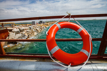 Aktau, Kazakhstan - May 19, 2012: Lifebuoy ring on balustrade. Caspian Sea, Aktau LPG gas loading...