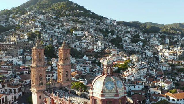 Taxco de Alarcon, Mexico. Flying Above Santa Prisca Church and Cityscape on Sunny Morning, Drone Shot