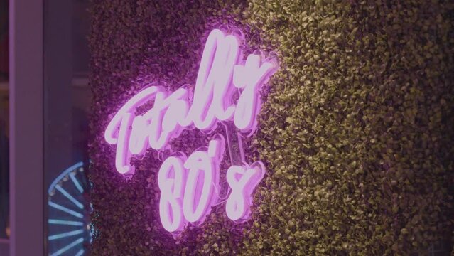 Retro 80's kitsch hot pink neon sign vintage lighting practical shot