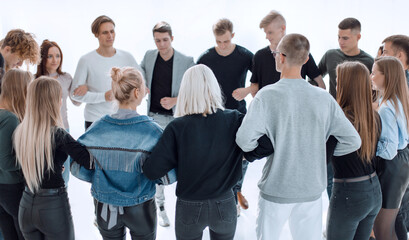 group of different young people standing in a circle