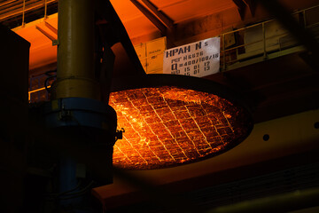 Temirtau, Kazakhstan - June 08, 2012: Arcelor Mittal metallurgy plant. Magnetic crane hand with...