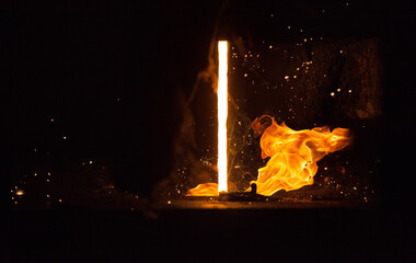 Close-up of liquid metal jet. Taking samples on molten metal on smelter.