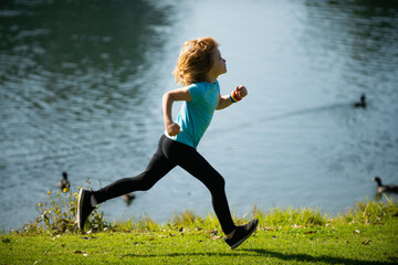 Kids running outdoors. Child runner jogger running in the nature. Morning jogging. Active healthy kids lifestyle.