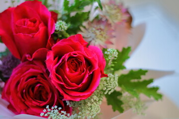 Closeup of a bouquet with red roses.