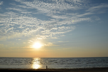 Young girl doing a morning jog on the beach