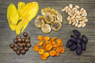 Mixed dried fruits. Symbols of the Jewish holiday Tu Bishvat. Figs, dried apricots, prunes, nuts, almonds, dried mangoes, Mikadamia nuts.