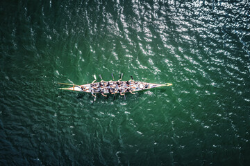 Overhead view of dragon boat racing team.