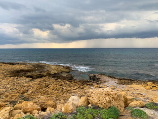 Fototapeta na wymiar Dark clouds at the seascape, natural colors, rocky coastline