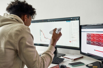 Frustrated african american trader after stocks market chart going down