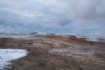 Gunnuhver sulphur springs on the Reykjanes peninsula with the Reykjanesta lighthouse