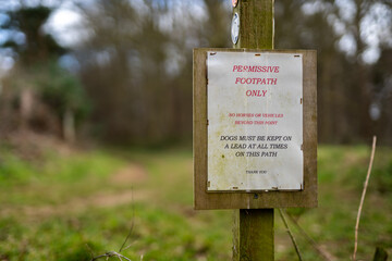 A rural countryside information sign informing the public that no horses or vehicles are allowed beyond this point and that all dogs must be kept on a lead while in the area