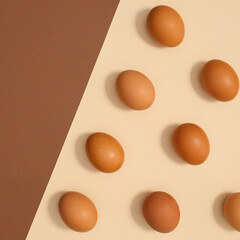 Ogranic eggs for Easter on bright pastel beige and brown background. Flat lay minimal pattern