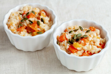 Two bowl of porridge with pumpkin and pumpkin seeds