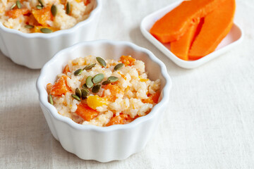 Porridge with pumpkin and pumpkin seeds on white table