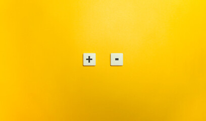 Plus and Minus Sign on Letter Tiles.