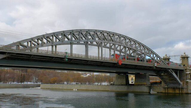 Moscow. Russia. Luzhnetsky Bridge over the Moskva River and the Lastochka MCC electric train. Winter view.