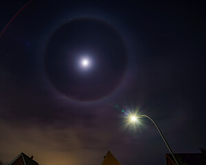 Moon halo phenomenon. Bright ring around the moon effect. Amazing and mysterious astronomical...