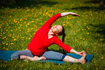 Pregnancy yoga exercise - pregnant woman doing asana Parivrtta Janu Sirsasana Revolved Head-to-Knee...