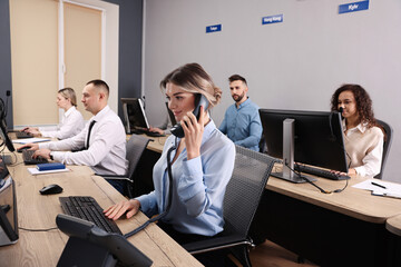 Call center operators working in modern office